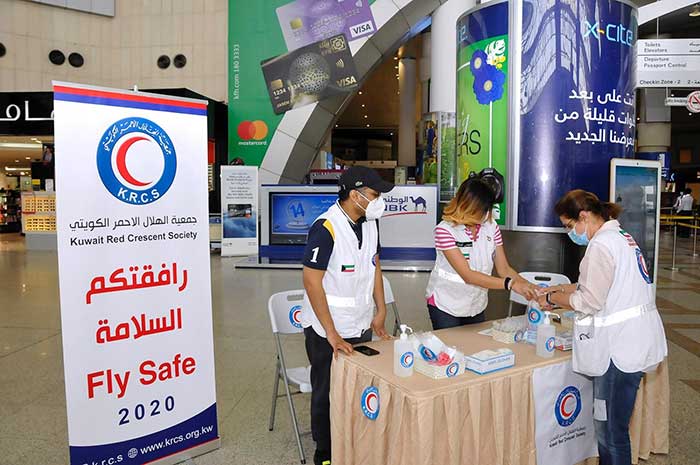Red Crescent Society distributed masks and sterilizers to passengers at Kuwait  Airport